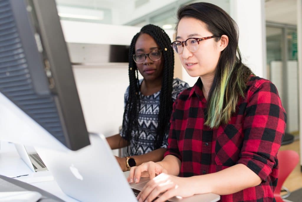 deux femmes devant un ordinateurs cherchant une interim